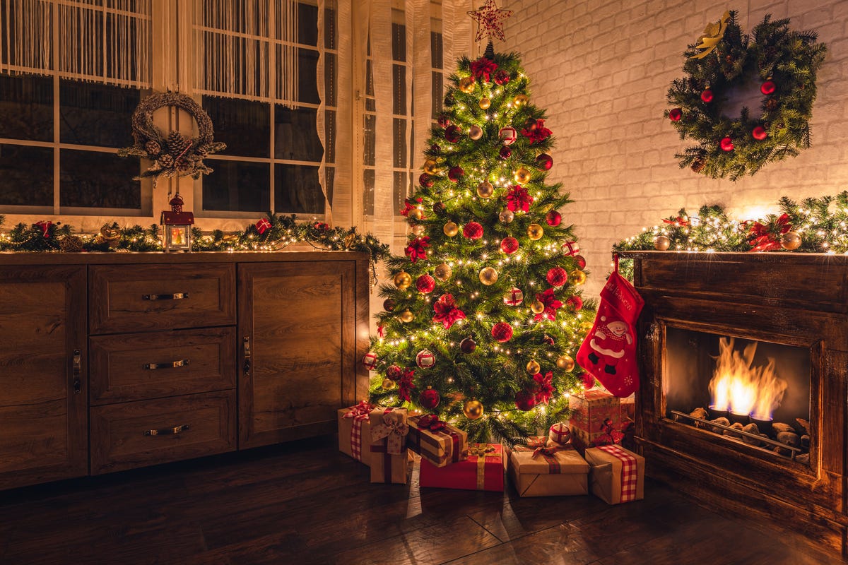 decorated christmas tree near fireplace at home