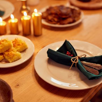 decorated dining table with traditional jewish food for hanukkah