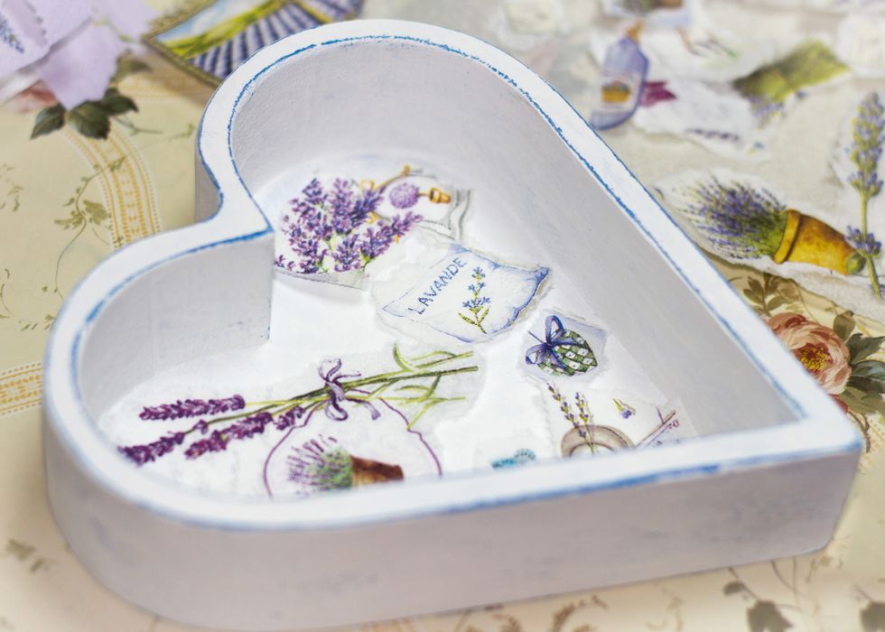 white wooden heart shaped box, with decoupage images of lavender on the bottom of it and cut out paper around it