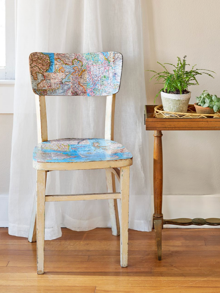 Vintage wooden chair with decoupaged maps on the back and seat