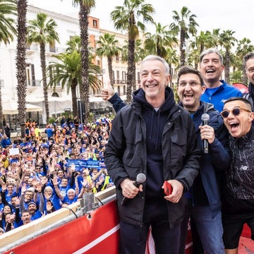 a group of people posing for a photo in front of a large crowd