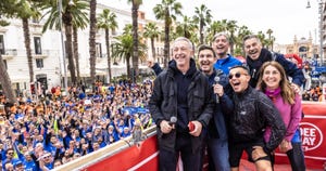 a group of people posing for a photo in front of a large crowd