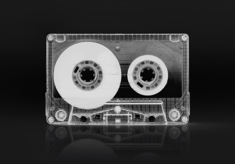 frontal view of a cassette audio tape with black background