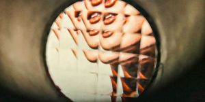 a distorted image of a womans mouth shown through a kaleidoscope