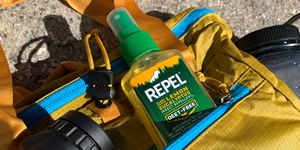 repel deet free natural bug spray in backpack with binoculars and water bottle