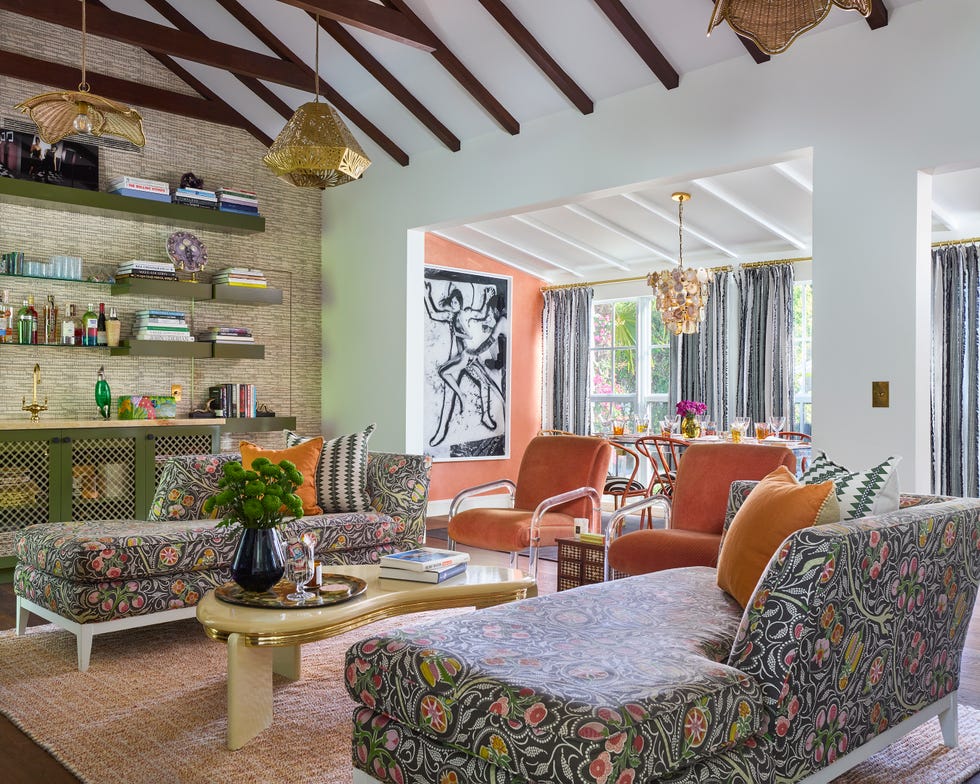 Living room with patterned sofa and orange accent chairs