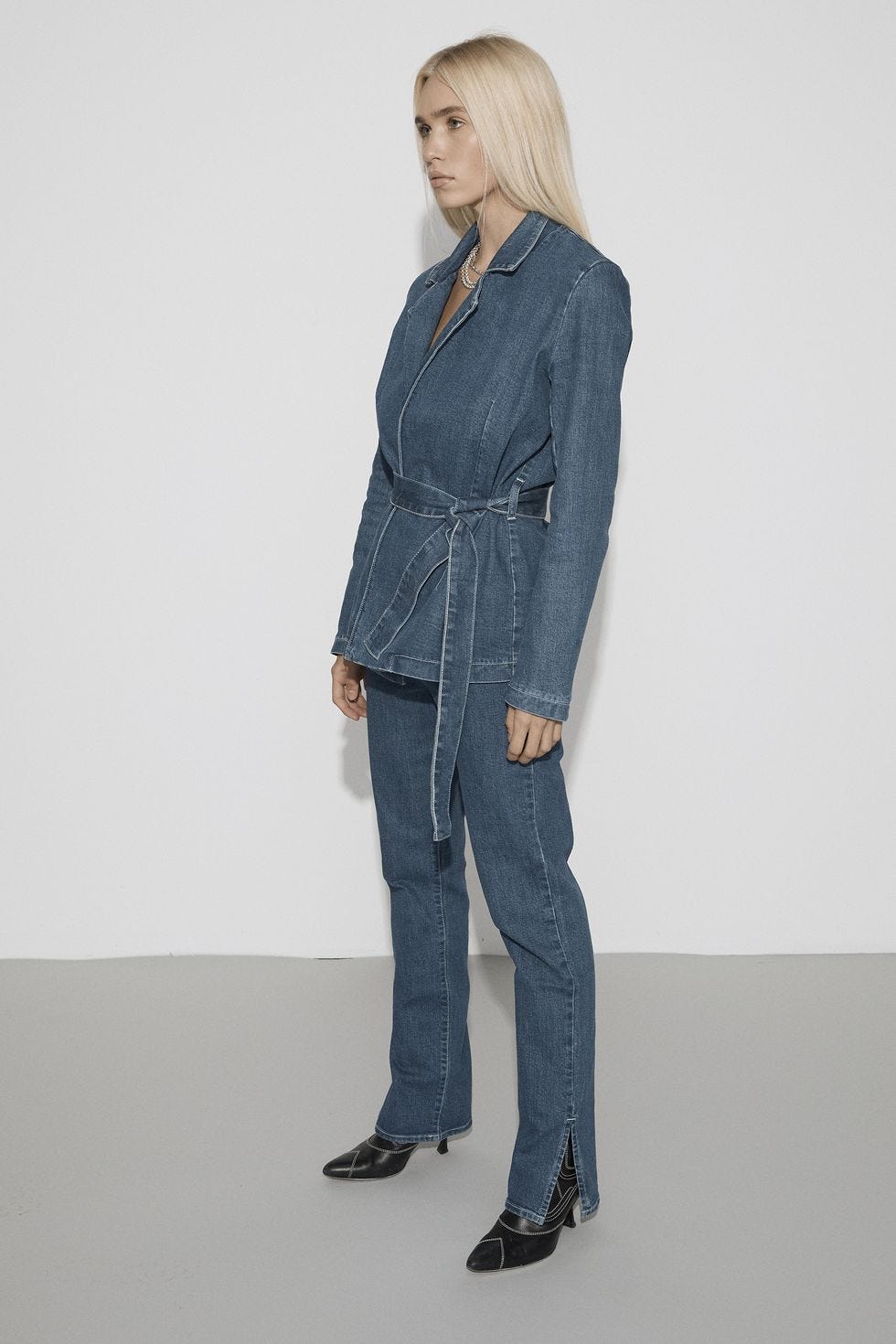 a person wearing a blue coat a person wearing a blue coat