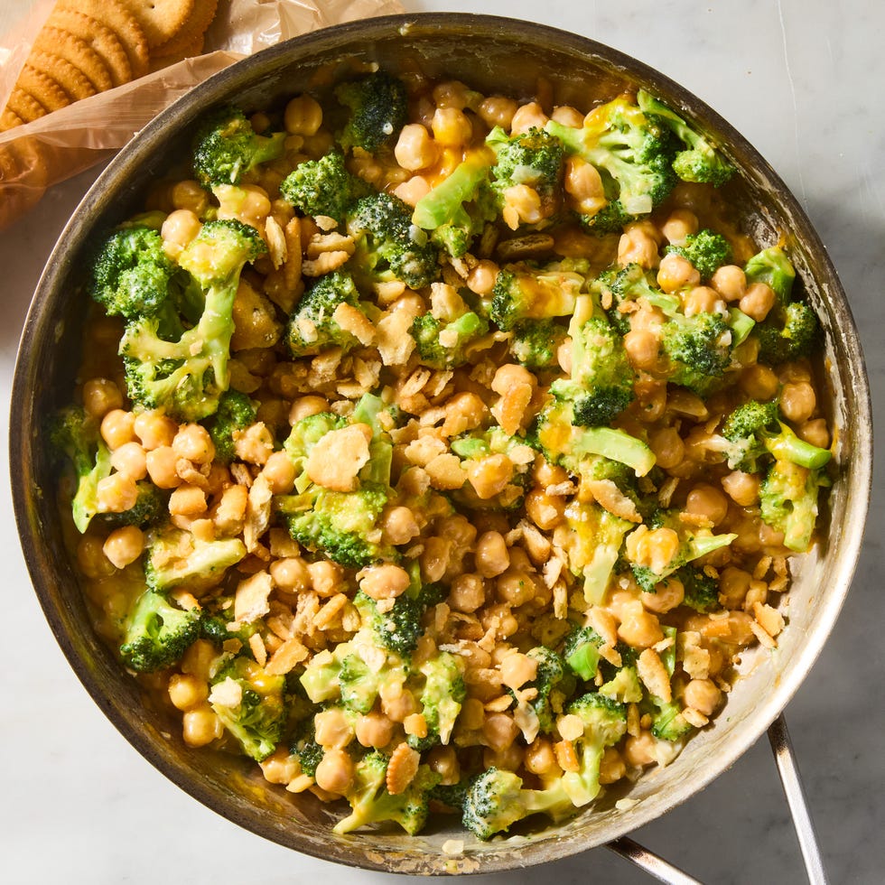 cheesy broccoli cheddar chickpeas in a skillet topped with crushed ritz crackers