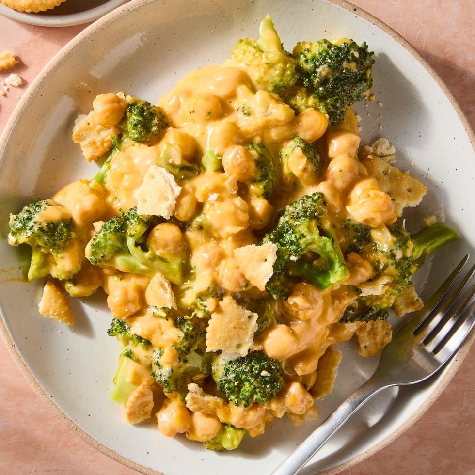 cheesy broccoli cheddar chickpeas on a plate topped with crushed ritz crackers