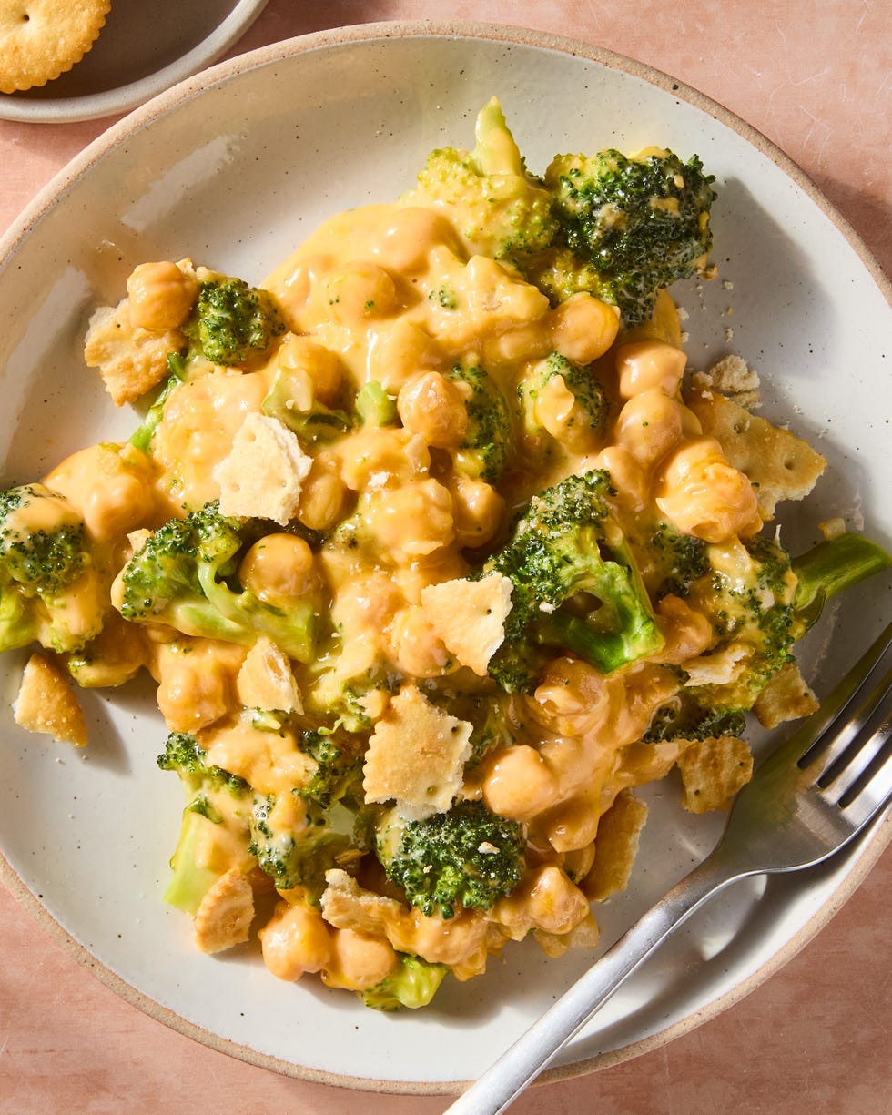 cheesy broccoli cheddar chickpeas on a plate topped with ritz crackers