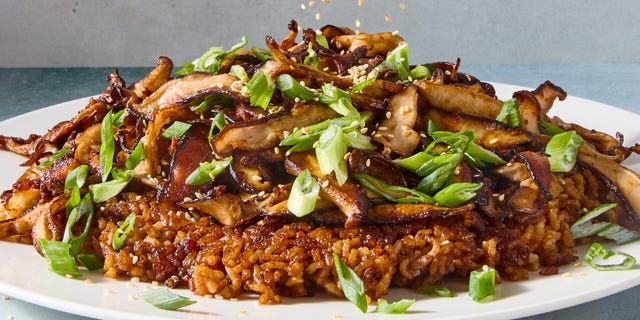 red miso sushi rice cooked in butter until a deep golden brown and topped with ginger and garlic studded mushrooms, and drizzled with spicy miso mayo