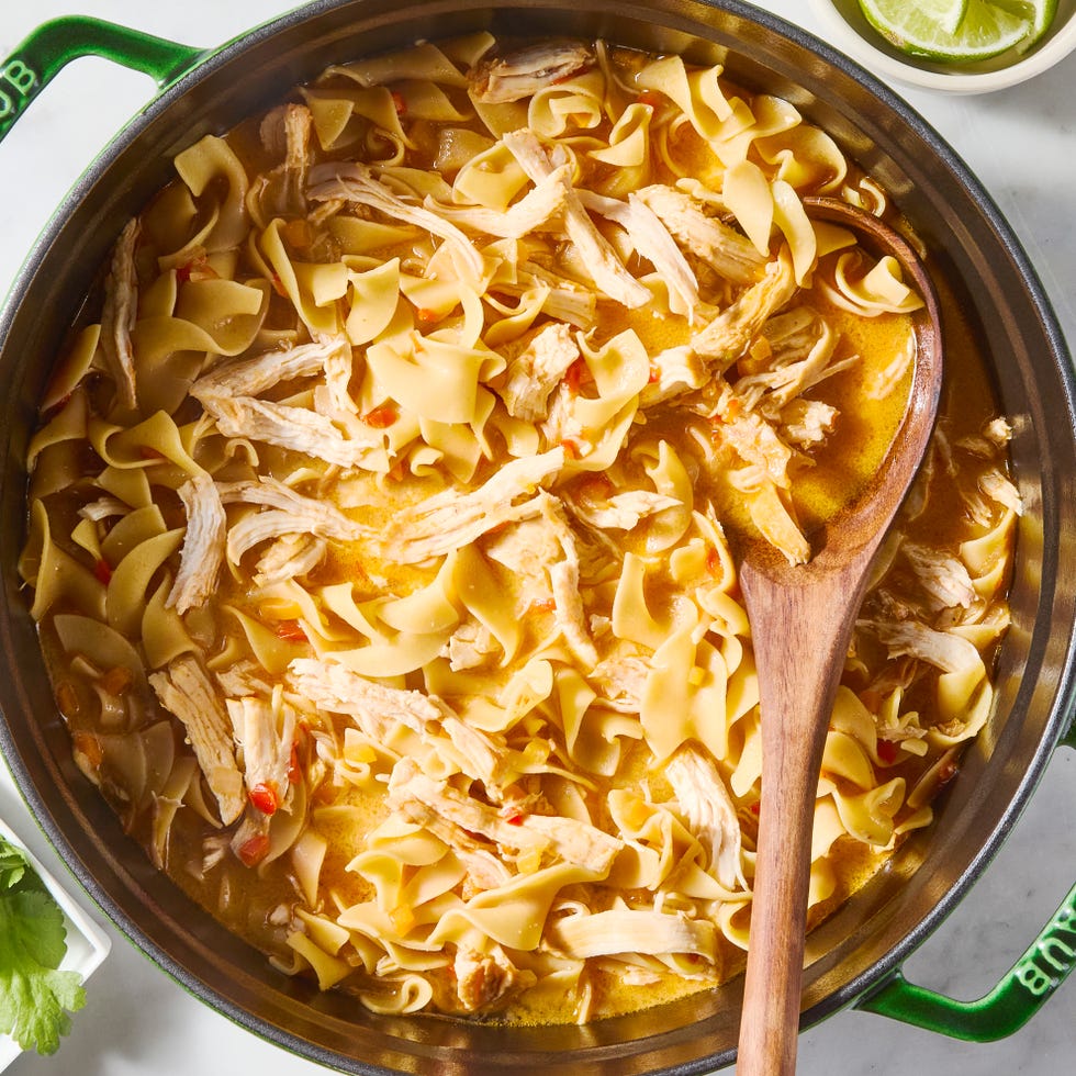 a pot of chicken noodle soup with a curry base