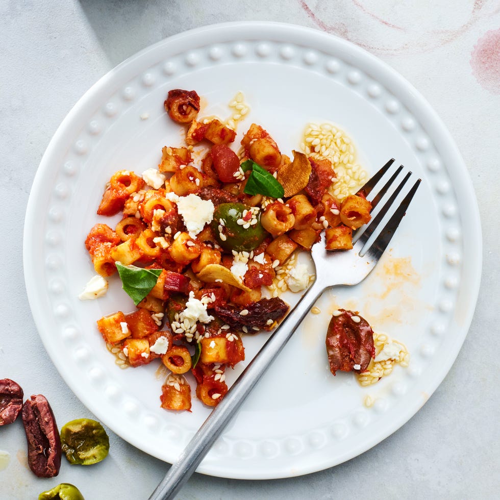 spicy ditalini pasta with sun dried tomatoes, basil, garlic olives, chopped anchovies, chiles, and crumbled feta