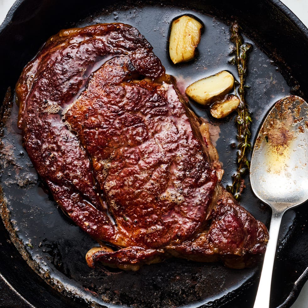reverse sear steak in a cast iron skillet with garlic and thyme