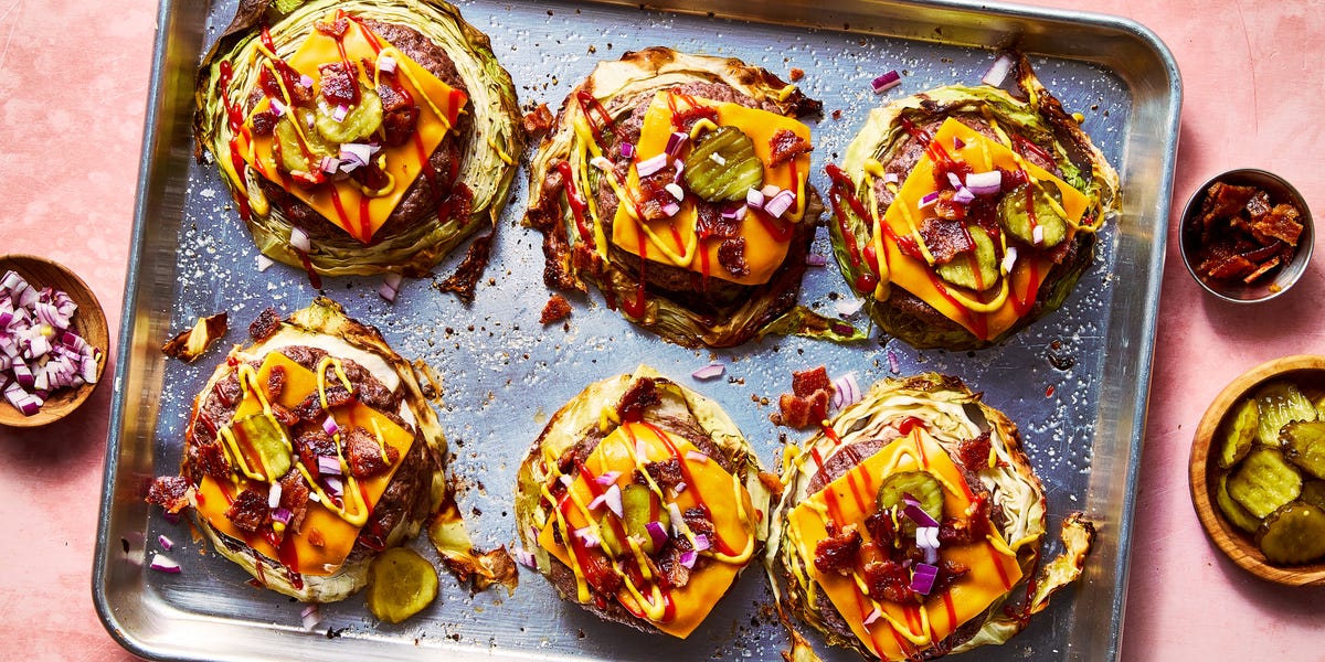 Roasted cabbage burgers roasted cabbage burgers on a sheet tray topped with american cheese, bacon, red on ion, pickles, ketchup, and mustard