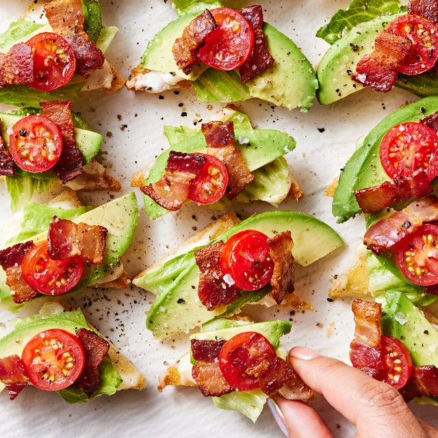 white toast points topped with lettuce, avocado, lettuce, and tomato