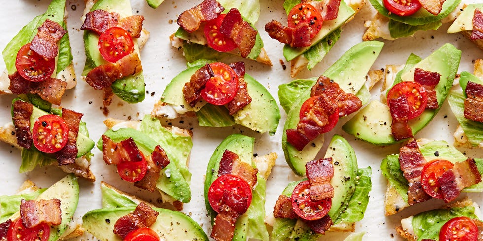 white toast points topped with lettuce, avocado, lettuce, and tomato