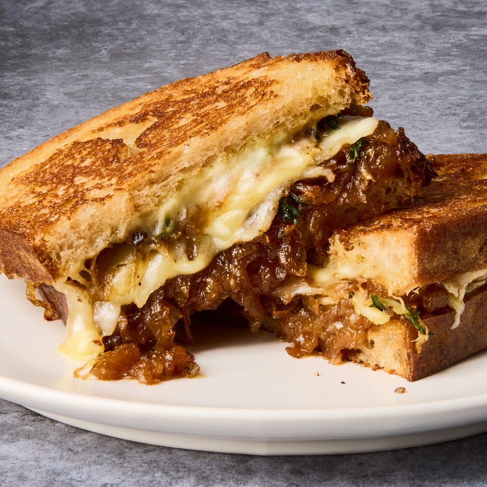 french onion grilled cheese sandwich on a white plate
