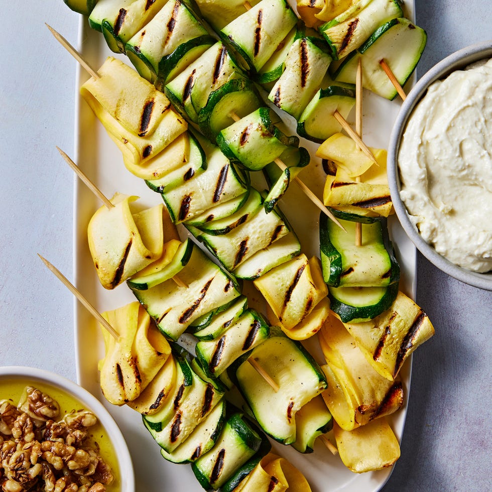 skewered and grilled zucchini planks topped with herby whipped ricotta and crunchy toasted walnuts