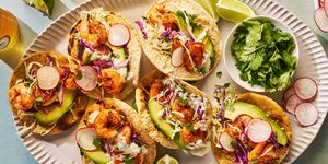 seasoned and seared shrimp topped with crisp cabbage slaw and creamy pickled jalapeno crema on a toasted corn tortilla