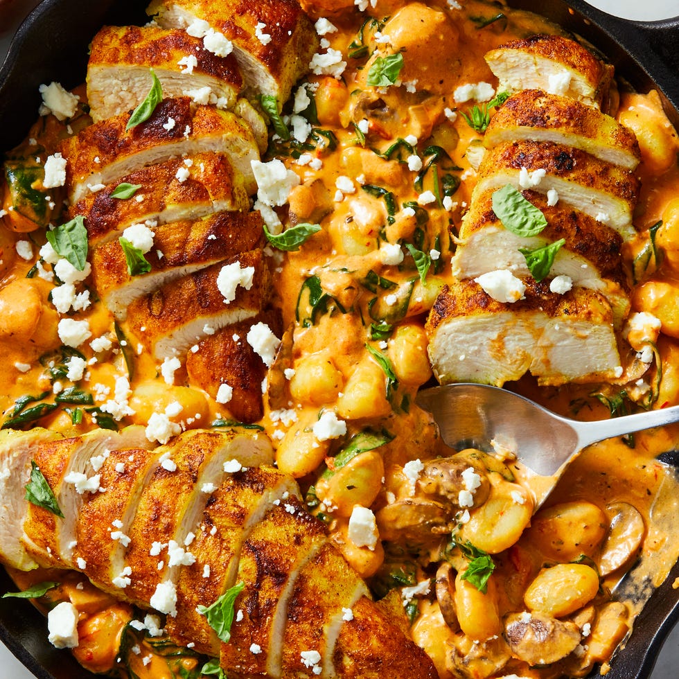 pillowy gnocchi in a creamy harissa sauce with ras al hanout spiced chicken, sliced mushrooms, spinach, and crumbled feta