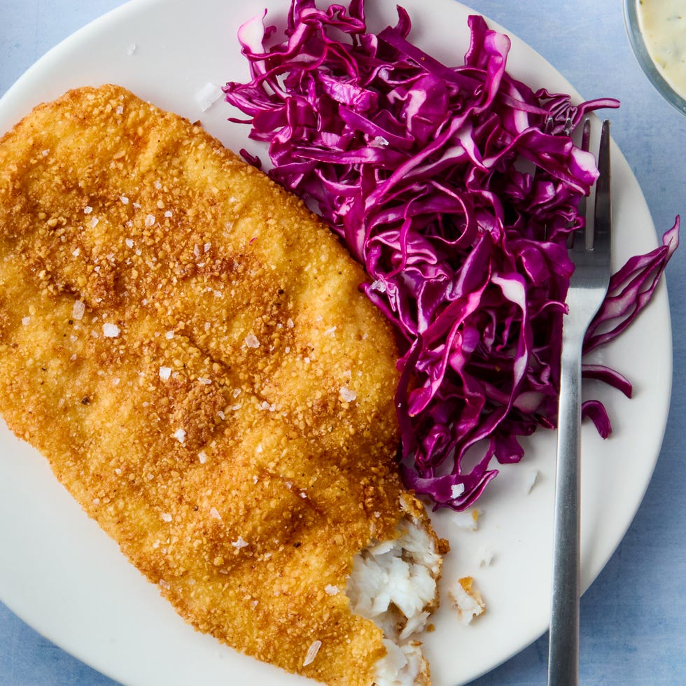 matzo fried fish on a plate with cabbage