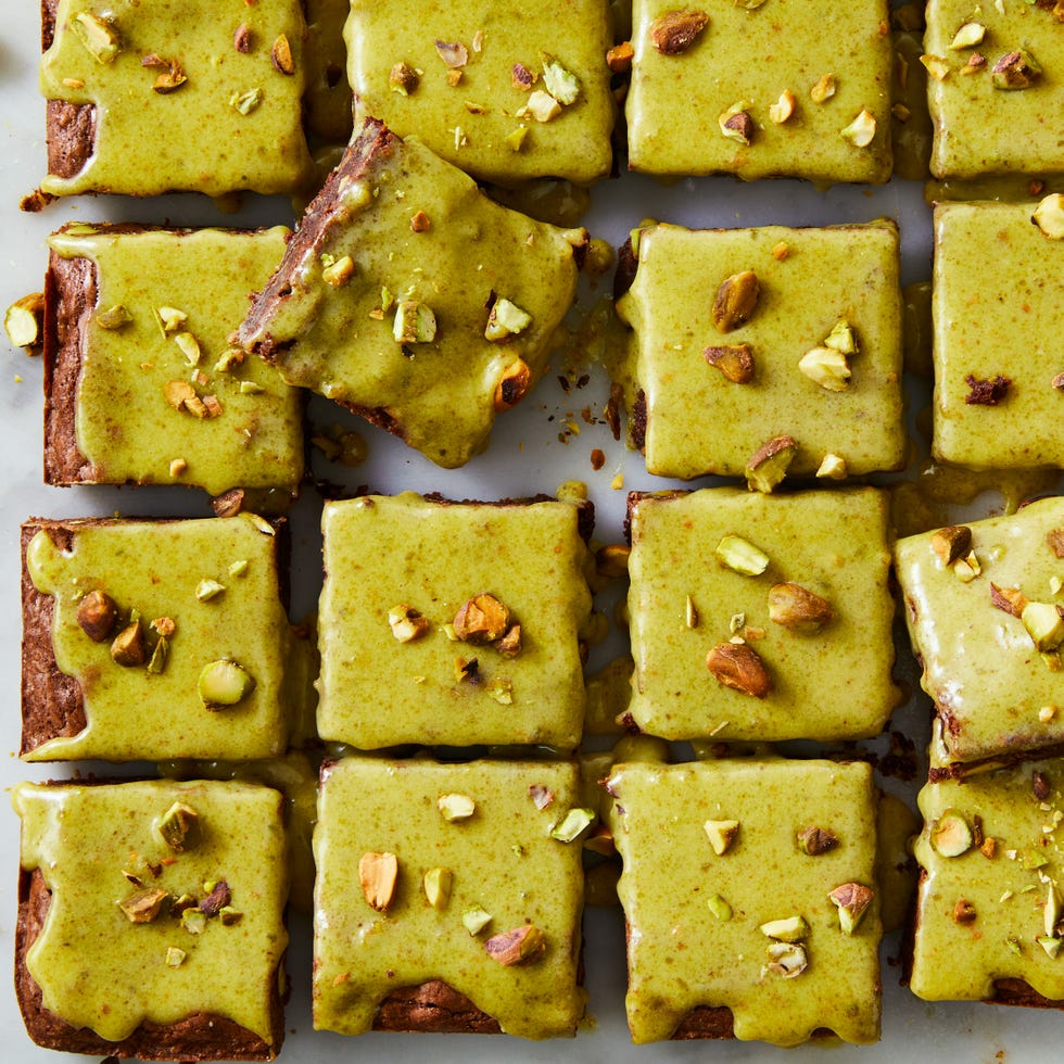 melted dark chocolate and cocoa powder brownies blended baked with chopped roasted pistachios and topped with homemade pistachio ganache