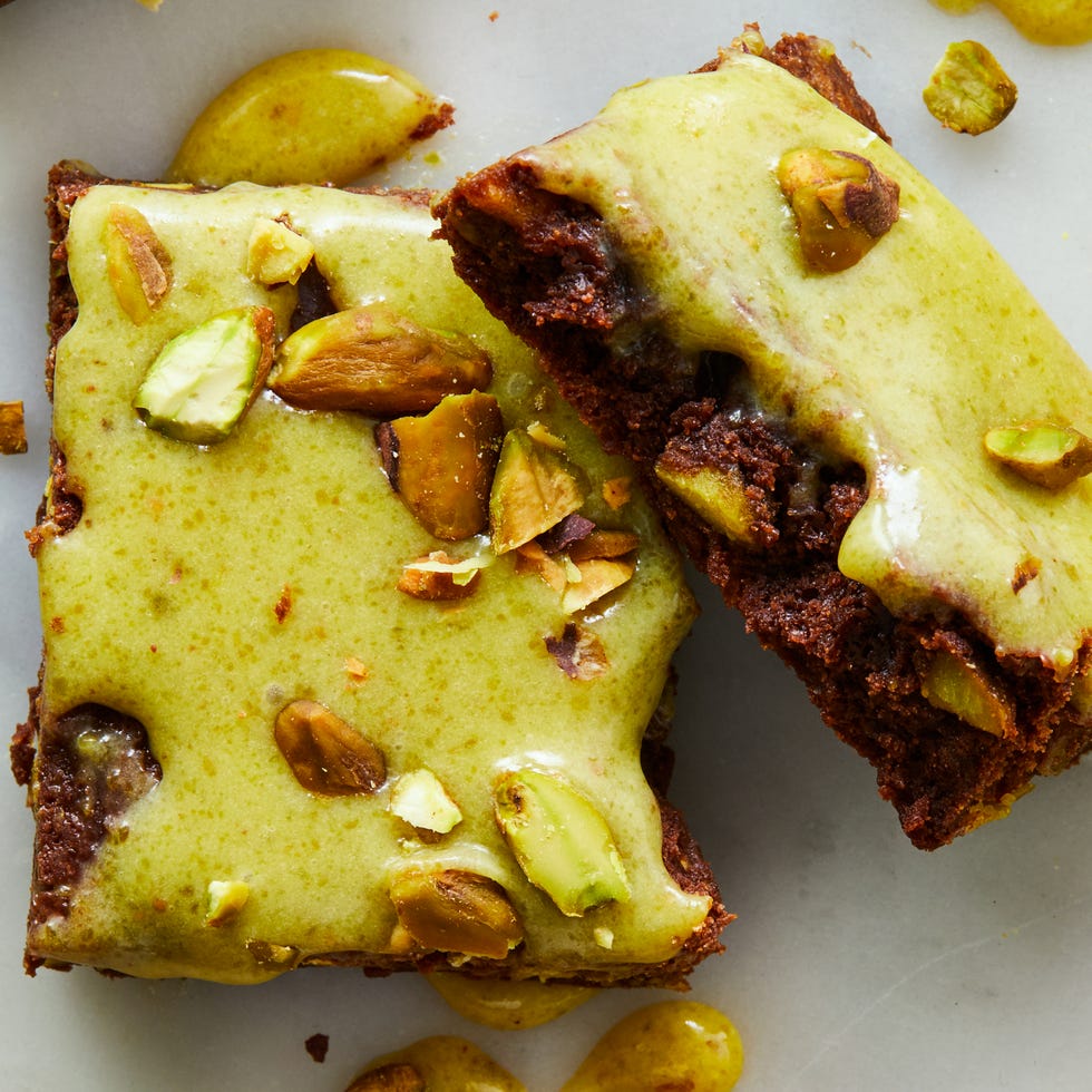 melted dark chocolate and cocoa powder brownies blended baked with chopped roasted pistachios and topped with homemade pistachio ganache