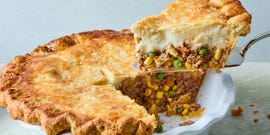 wine spiked ground beef and vegetable mixture topped with fluffy parmesan mashed potatoes, all wrapped in a golden brown pie crust and topped with flaky salt