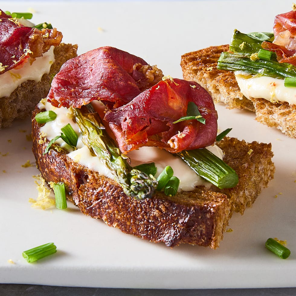 mini toasted sourdough with fluffy whipped ricotta, roasted asparagus, and crispy prosciutto