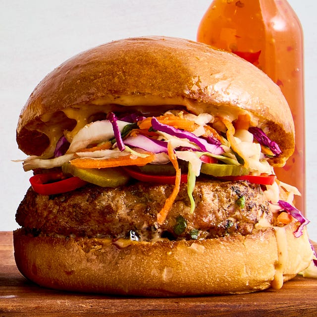 Thai Sweet Chili Turkey Burger a ginger, garlic, and scallion studded turkey patty, pickled spicy peppers and cucumbers, a bright, crisp cabbage slaw, and plenty of sweet chili mayo all on a shiny, fluffy brioche bun