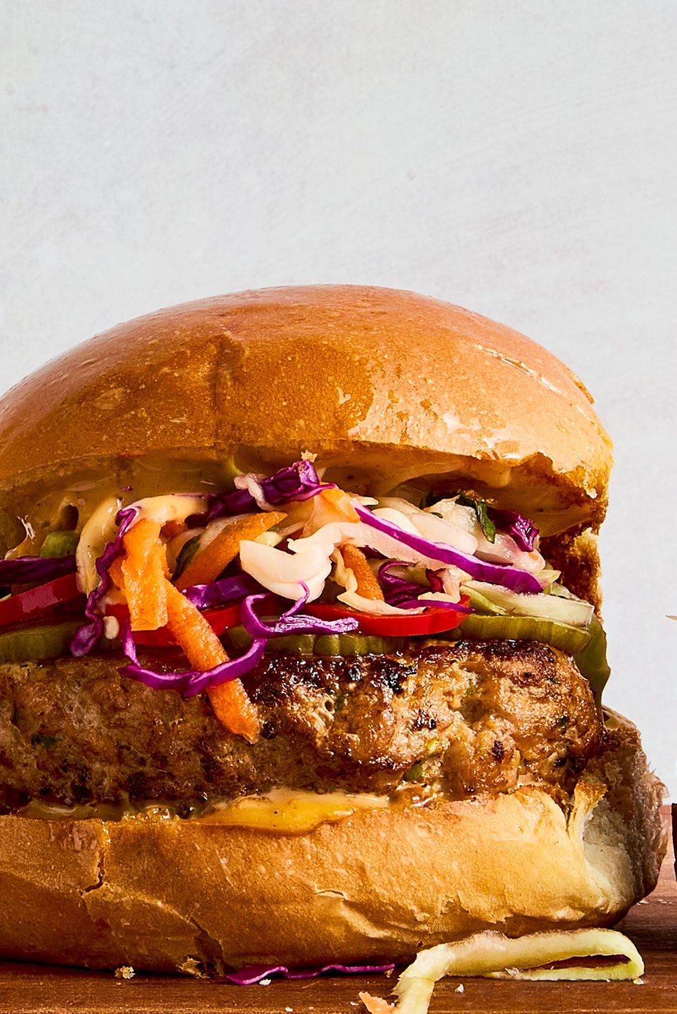a ginger, garlic, and scallion studded turkey patty, pickled spicy peppers and cucumbers, a bright, crisp cabbage slaw, and plenty of sweet chili mayo all on a shiny, fluffy brioche bun