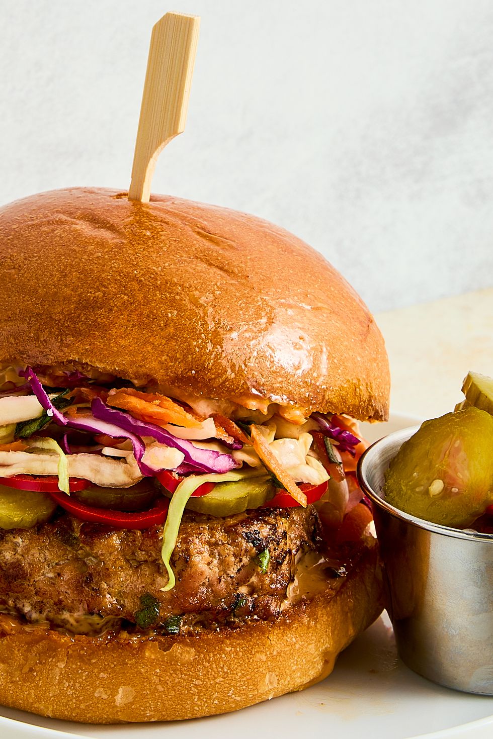 a ginger, garlic, and scallion studded turkey patty, pickled spicy peppers and cucumbers, a bright, crisp cabbage slaw, and plenty of sweet chili mayo all on a shiny, fluffy brioche bun