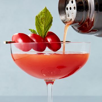 martini glasses with gin, tomato infused vermouth, and a basil leaf