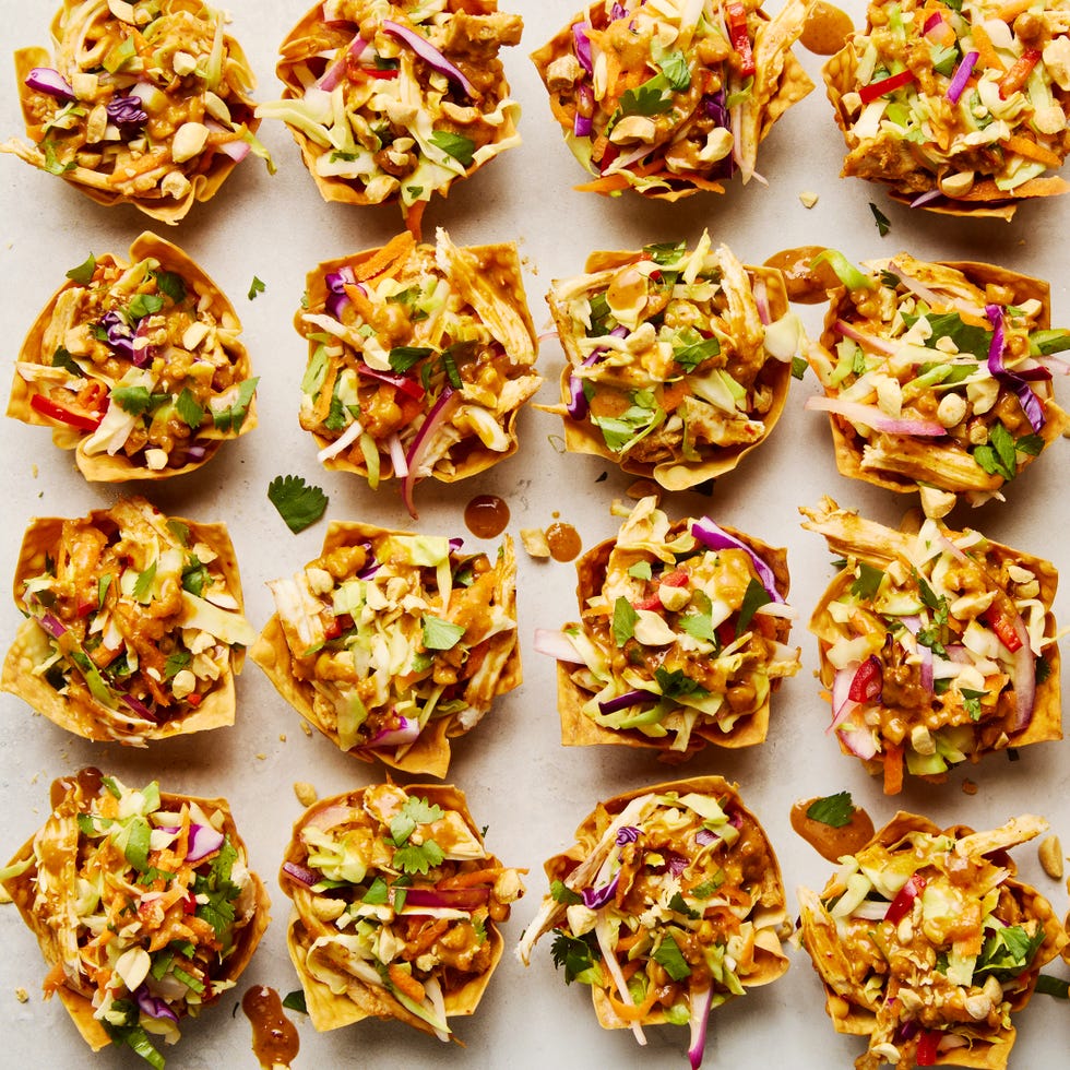 shredded rotisserie chicken gets tossed in a spicy sweet peanut sauce, stuffed in a crispy baked wonton shell, and topped with bright, colorful, and crunchy veggies to make this easy two bite app