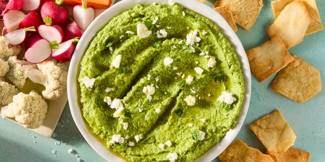 sweet spring peas are blanched until tender yet vibrant green, then blended with tangy feta cheese, basil, mint, and lemon for a luscious dip that's both creamy and savory