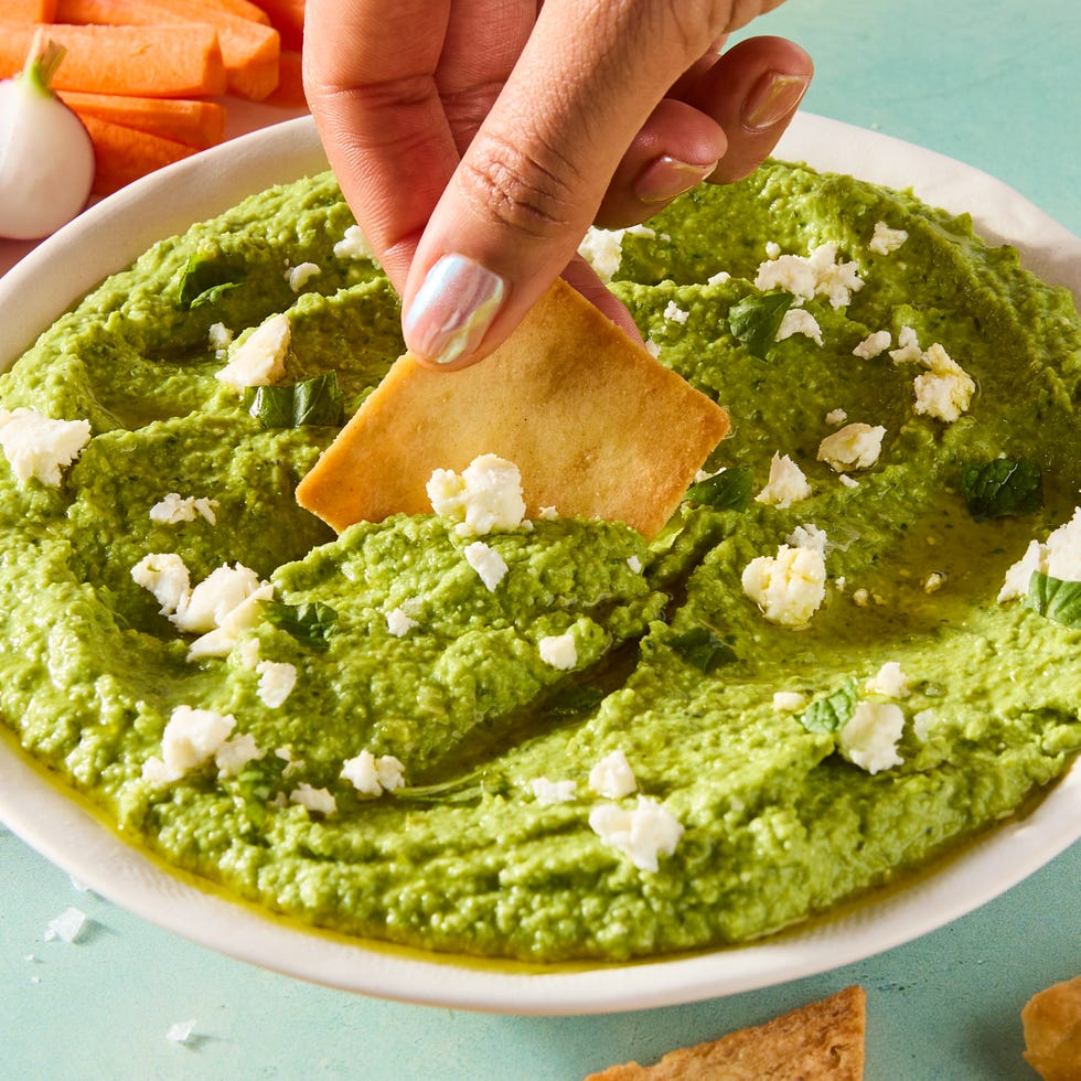 sweet spring peas are blanched until tender yet vibrant green, then blended with tangy feta cheese, basil, mint, and lemon for a luscious dip that's both creamy and savory