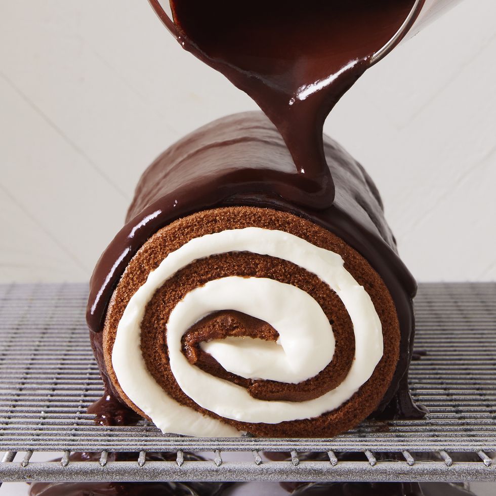 swiss roll on baking sheet with ganache poured over