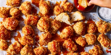 crispy hot honey cauliflower nuggets drizzled with hot honey sauce on white parchment