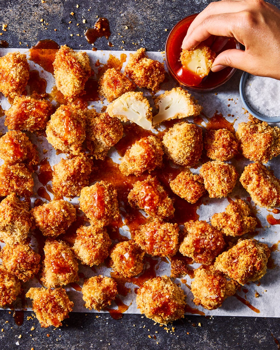 crispy hot honey cauliflower nuggets drizzled with hot honey sauce on parchment paper