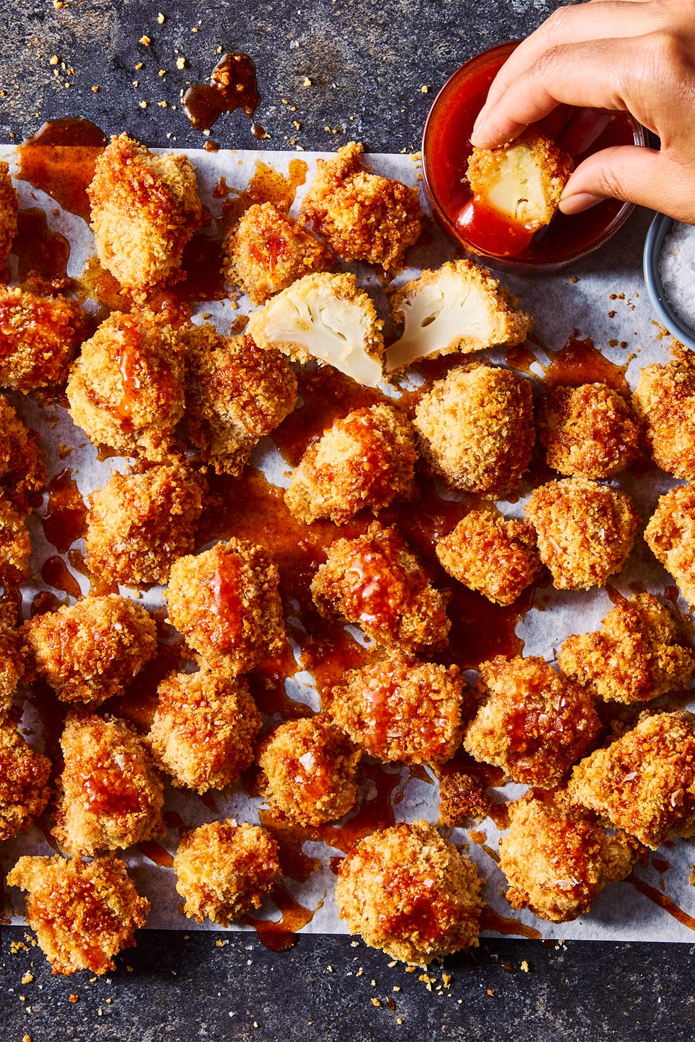 Crispy hot honey cauliflower nuggets crispy hot honey cauliflower nuggets drizzled with hot honey sauce on parchment paper