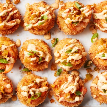 Cheesy Shrimp & Grit Bites smoked gouda grits, breaded and fried until crispy then topped with cajun seasoned shrimp and creamy remoulade sauce
