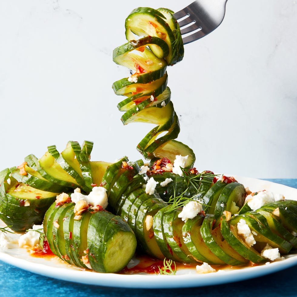 fork lifting a spiral of viral spiral cucumber salad dressed with harissa and feta