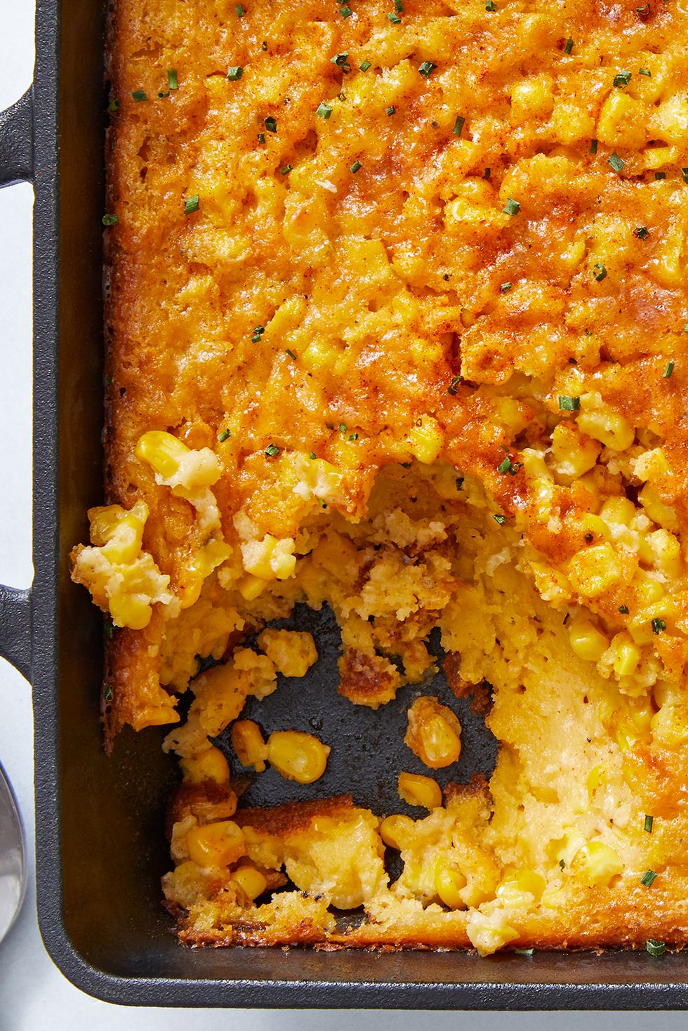 classic midwestern casserole made with jiffy muffin mix, creamed corn, and fresh corn then baked and topped with paprika and chives