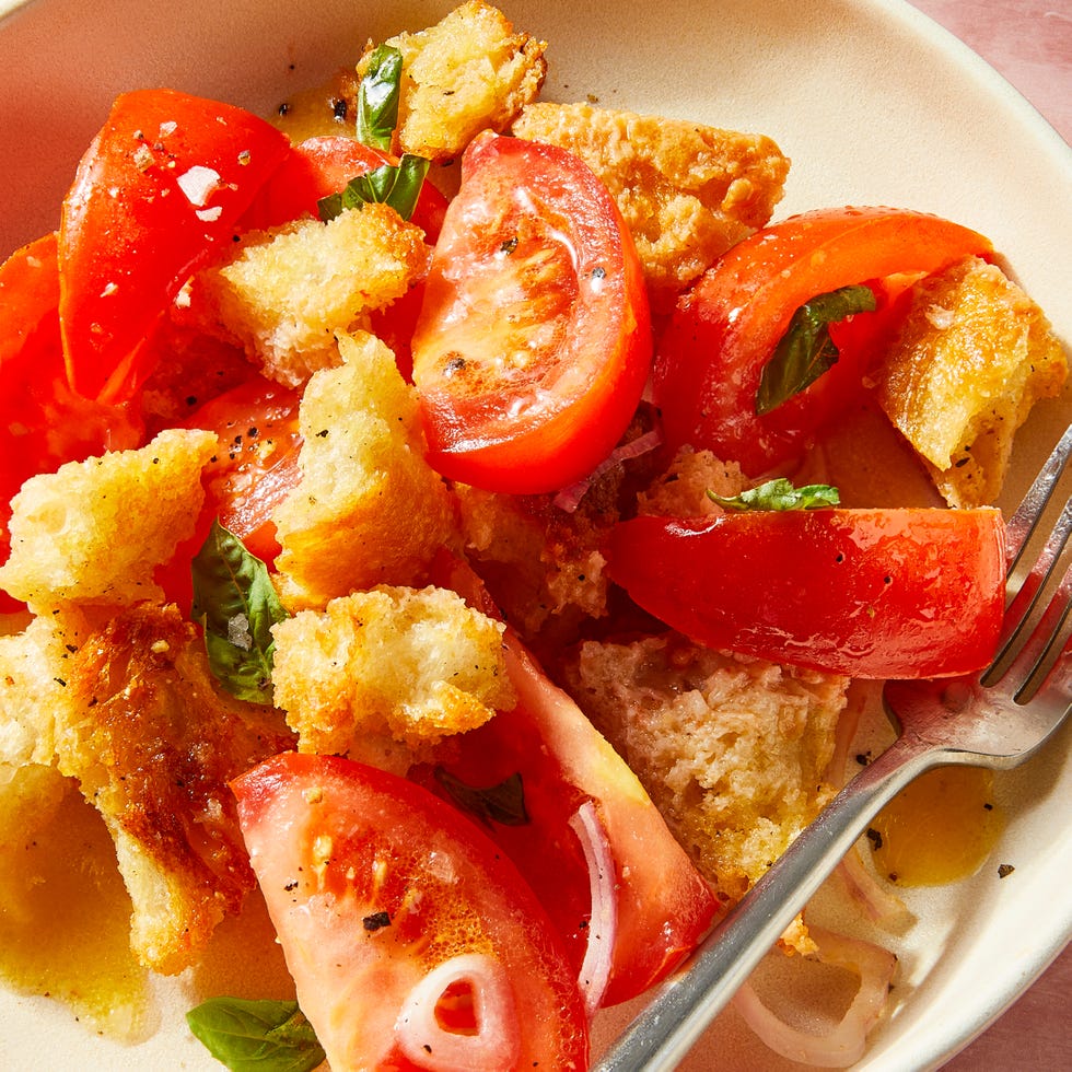 panzanella salad on a white plate with a fork
