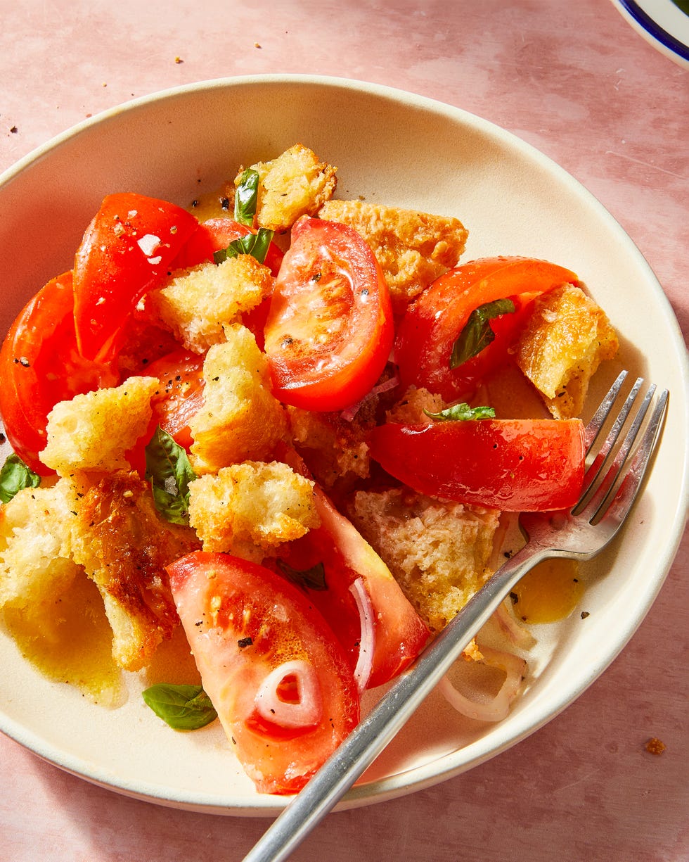 panzanella salad in a shallow white bowl with a fork