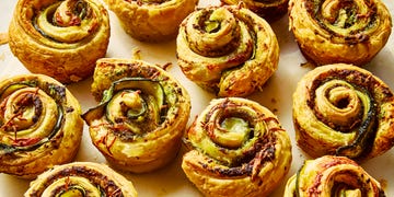 pesto zucchini roses on a white surface