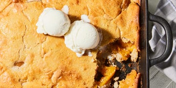 bisquick peach cobbler in baking dish with ice cream