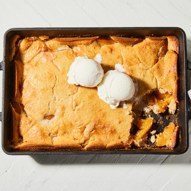 bisquick peach cobbler in pan with ice cream scoops
