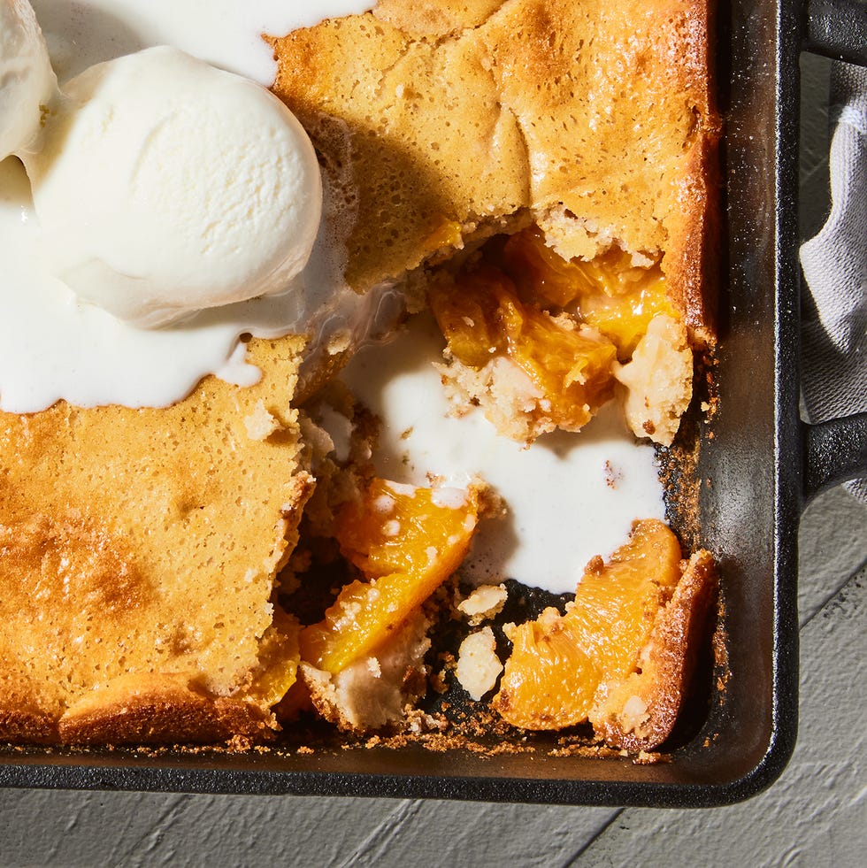 bisquick peach cobbler in baking pan with ice cream
